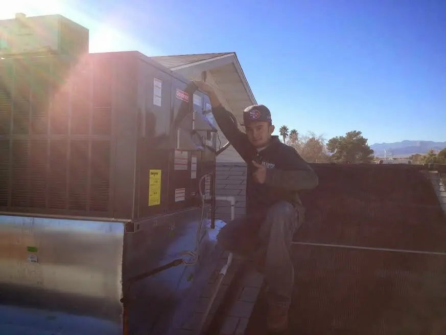 HVAC technician performing Boiler Repair on a rooftop unit in Cherryland